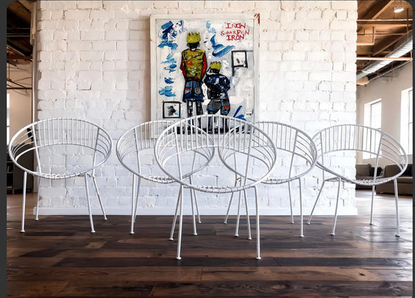 vintage mid-century white "Atomic Hoop" garden chairs.